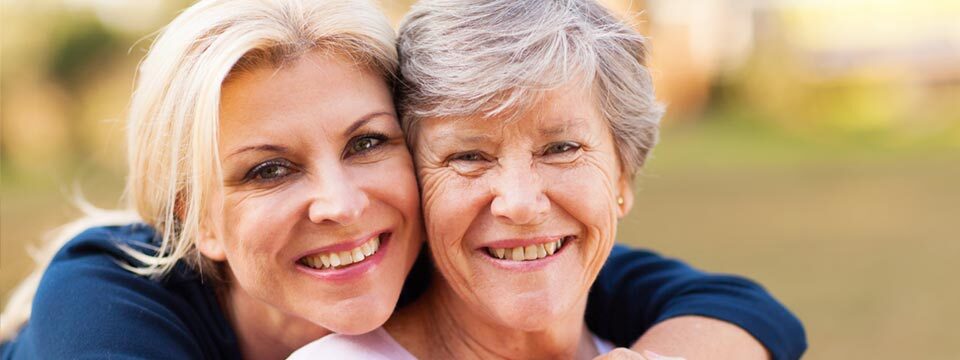 Older and younger woman embracing